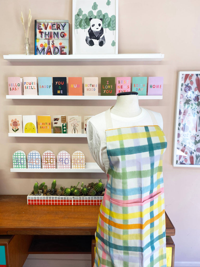 Bright Gingham Adult Apron – beautiful greeting card from C&K, an independent lifestyle store in Settle.