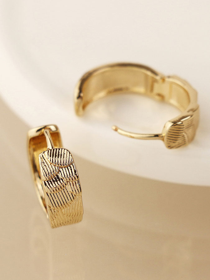 Faux Gold Scallop Embossed Huggie Hoops – stylish accessories from C&K, an independent lifestyle store in Settle, North Yorkshire.
