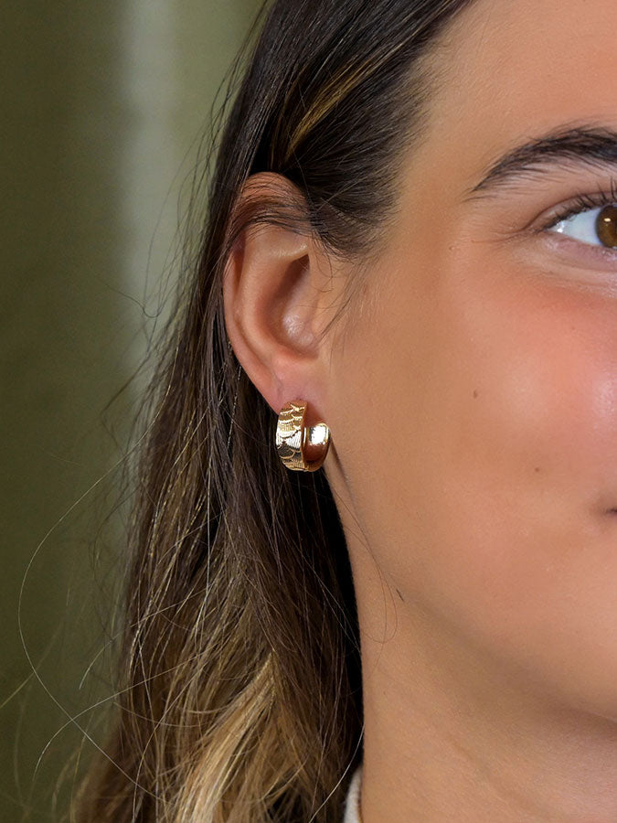 Faux Gold Scallop Embossed Huggie Hoops – stylish accessories from C&K, an independent lifestyle store in Settle, North Yorkshire.